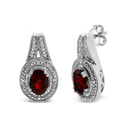 Bids.com .925 Sterling Silver Diamond Accent and 8x6mm Red Oval Garnet Stud Earrings (I-J Color, I1-I2 Clarity) Earrings White Smoke White.Sterling Silver / 0.048