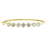 Bids.com 14K Yellow Gold Alternating Bezel Set 5MM Oval Shaped Tanzanite and 1/5 Cttw Diamond Bangle Bracelet (H-I Color, VS2-SI1 Clarity) - Fit's wrists up to 7.25" Inches Bracelets White Smoke Yellow.Gold / 7