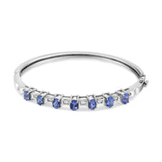 Bids.com 14K White Gold 5 MM Oval Blue Tanzanite and 1/4 Cttw Diamond Bangle (H-I Color, VS2-SI1 Clarity) - Fits wrists up to 7 1/2 Inches Bracelets White Smoke White.Gold / 7