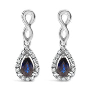 Bids.com 10K White Gold Pear Cut Blue Sapphire and 1/7 Cttw Diamond Infinity Drop and Dangle Earrings (I-J Color, I1-I2 Clarity) Earrings White Smoke White.Gold / 0.14